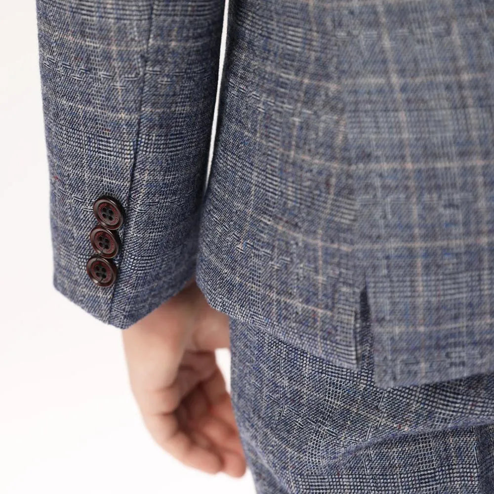 Close-up of blazer sleeve buttons and plaid texture on boys elegant grey suit jacket