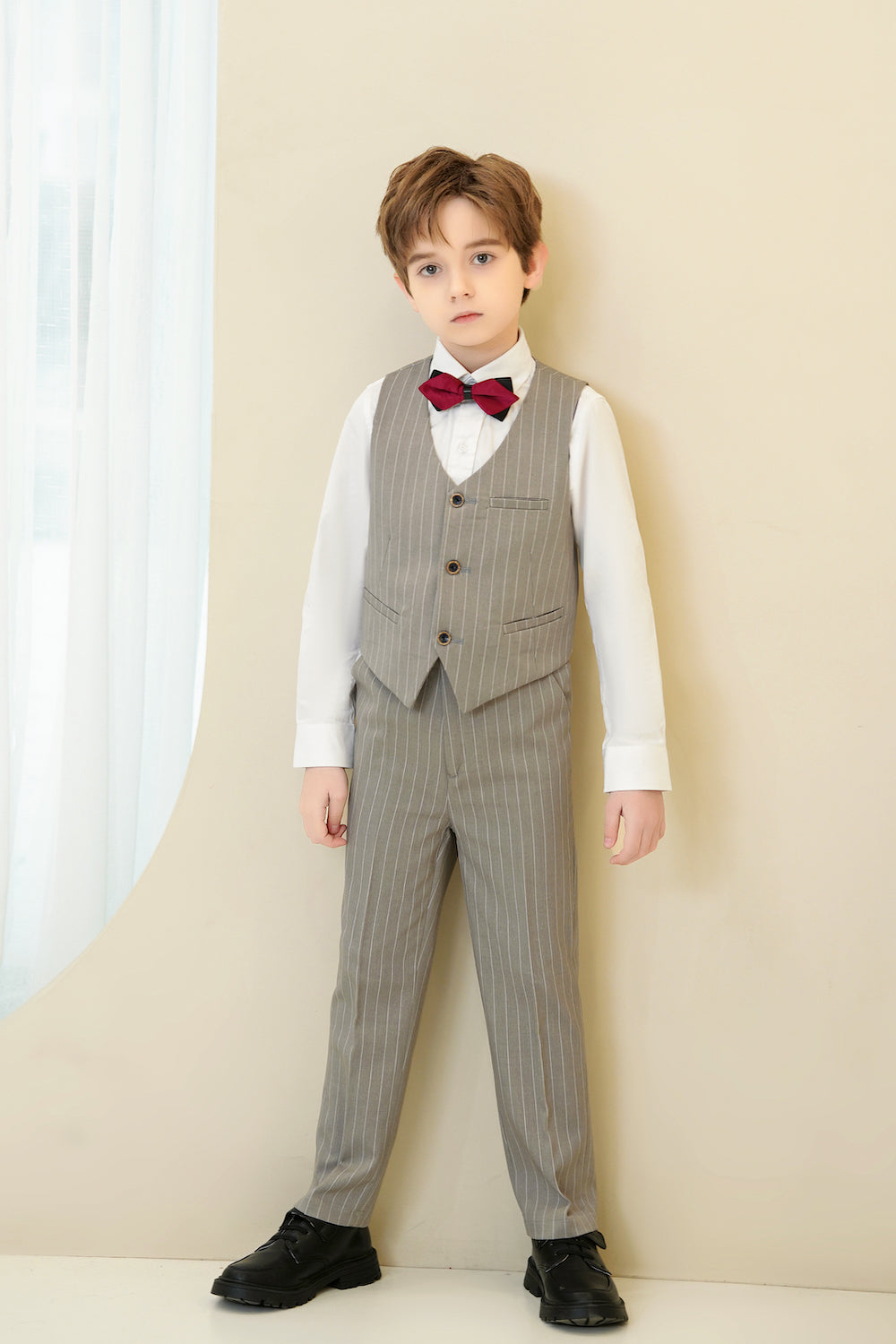 Full-body front view in light grey pinstripe vest and pants with bow tie – boy’s 4-piece formal outfit