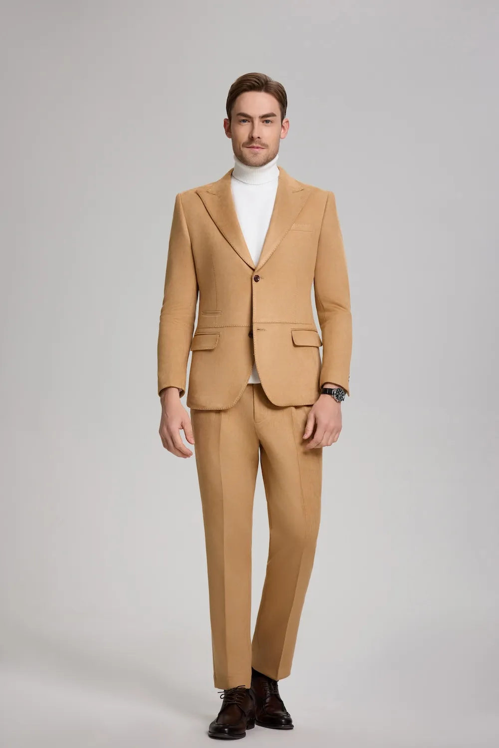 front view of a man in a light brown suede 2-piece suit with a peak lapel blazer and trousers.