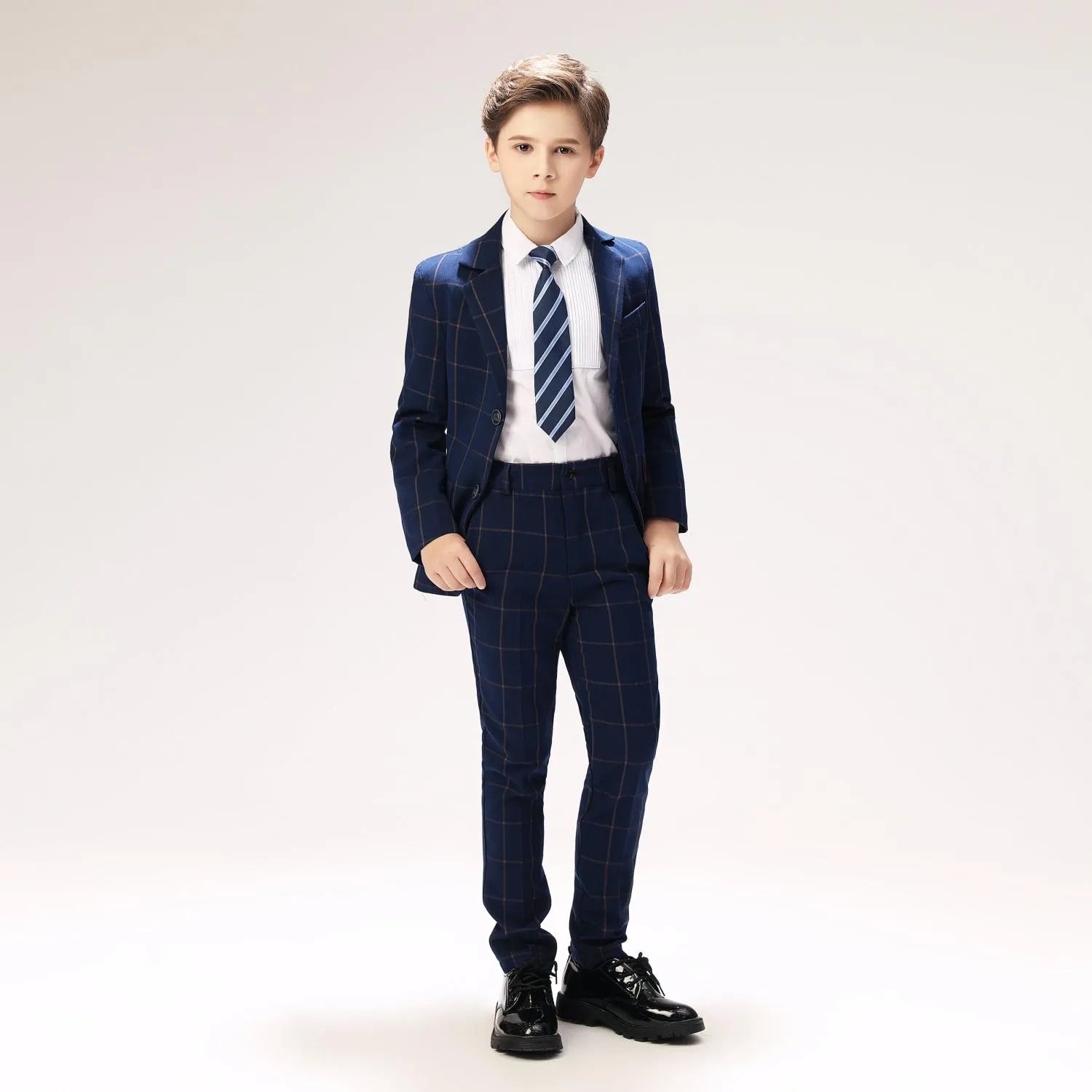 Smart plaid suit for boys with striped tie and blazer, perfect for weddings