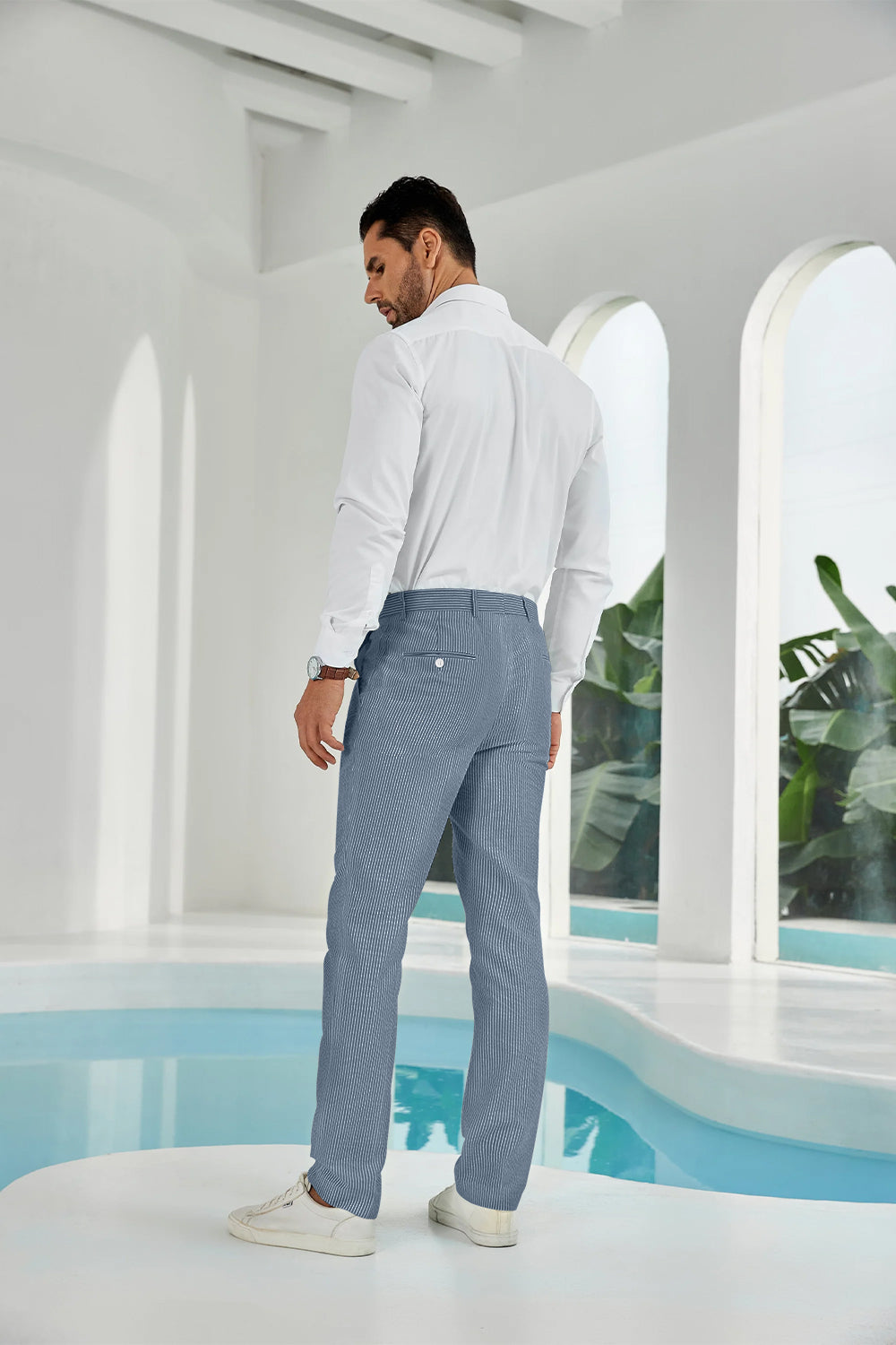 Three-quarter rear angle of navy pants showing slim fit and texture