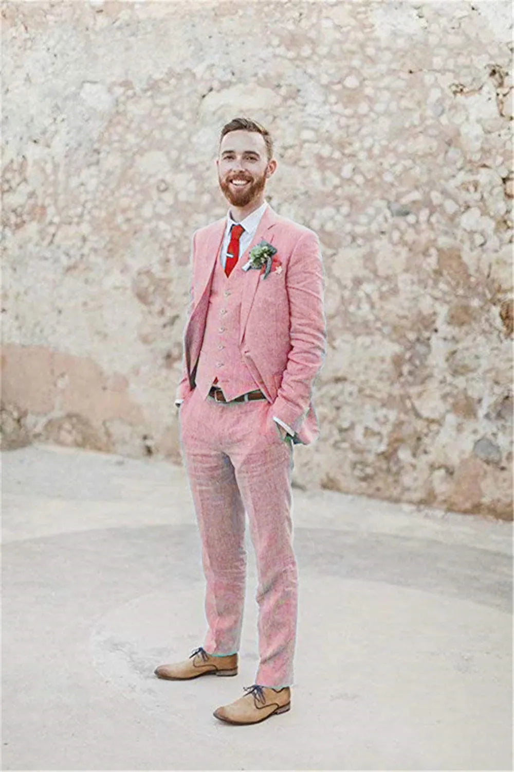 Full body view of men's pink 3 piece linen suit – retro slim fit wedding outfit with vest, blazer, pants, red tie and boutonniere