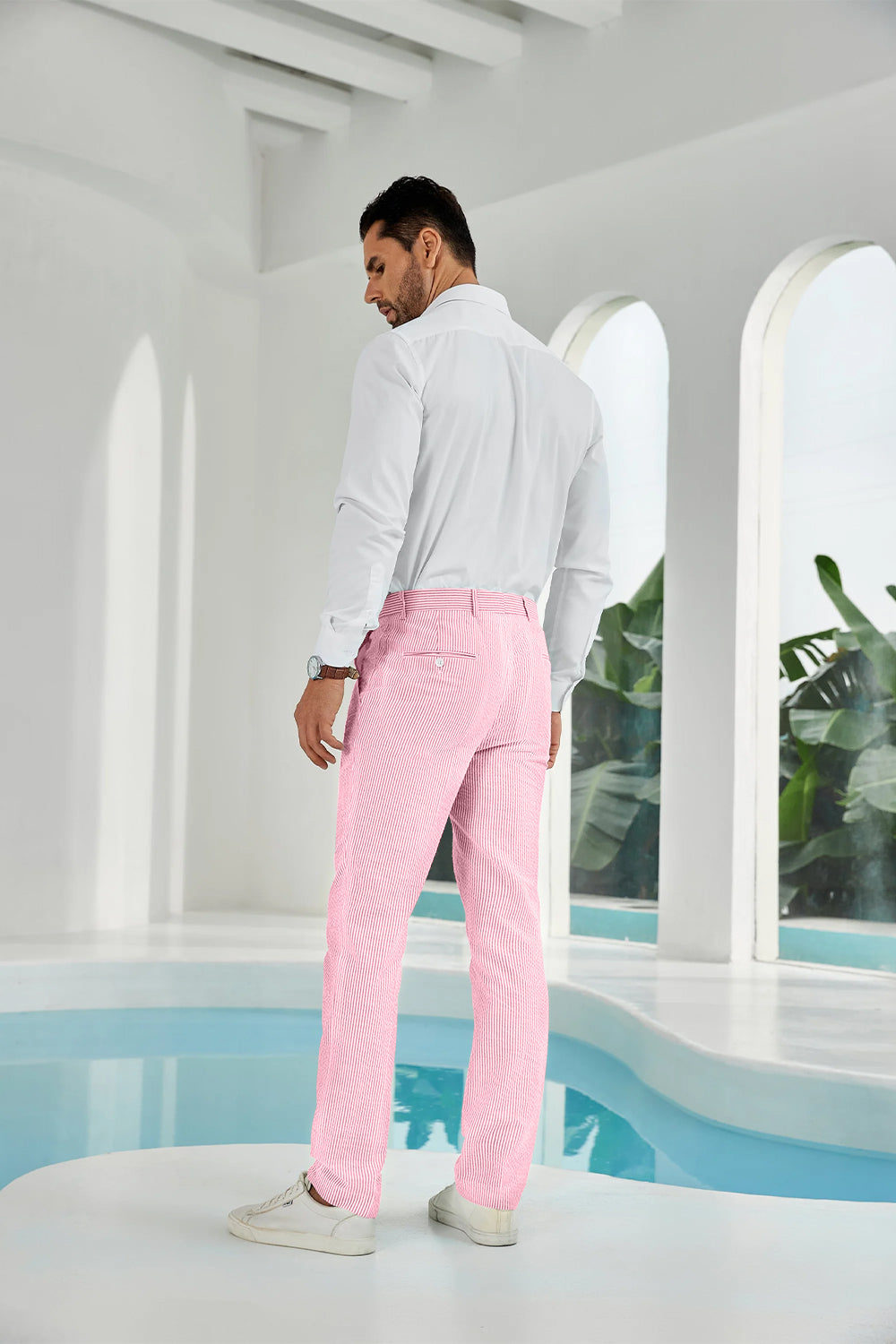Three-quarter rear angle of pink pants showing slim fit and texture