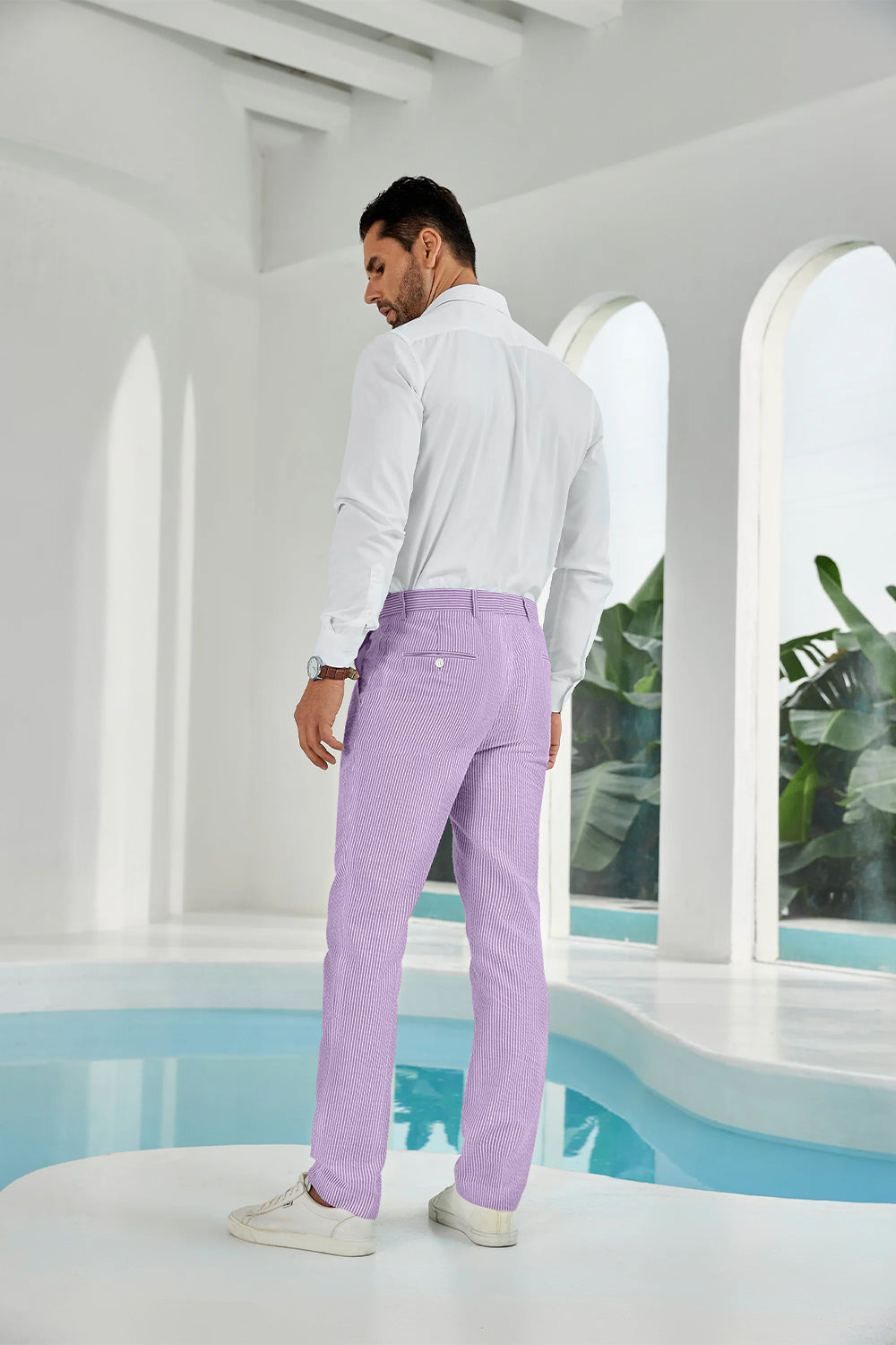 Three-quarter rear angle of purple pants showing slim fit and texture