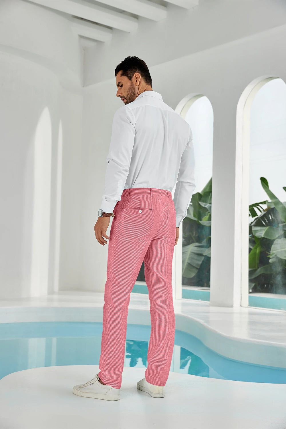 Three-quarter rear angle of red pants showing slim fit and texture