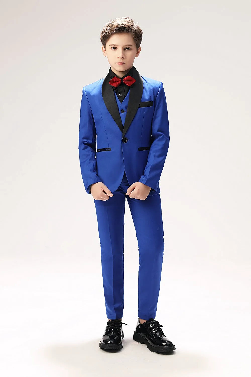 Royal blue boys' prom tuxedo with black lapel and red bow tie