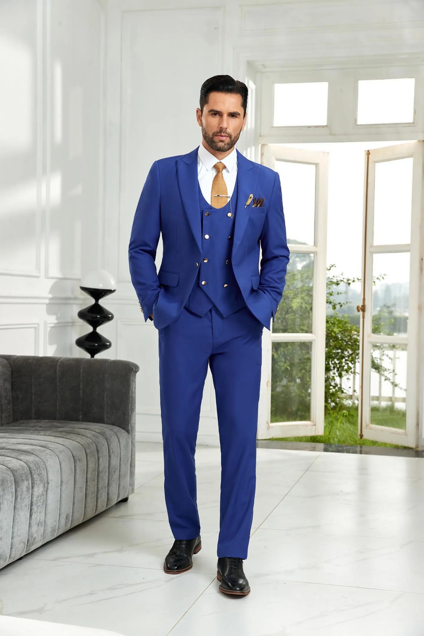 Model in royal blue 3 piece men's suit with tailored blazer, vest, and pants, showcasing a formal business and wedding look.