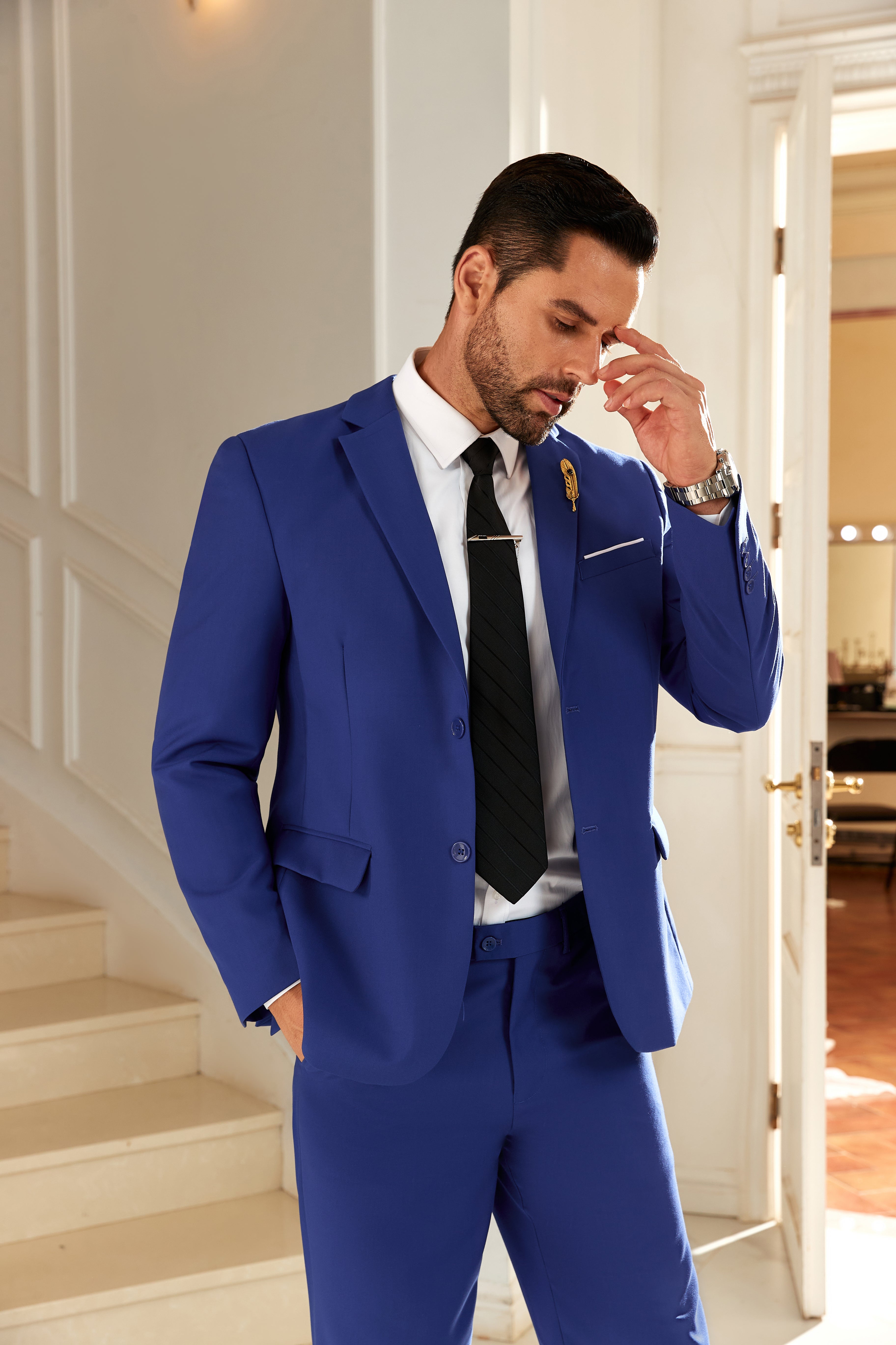 Model in royal blue men’s suit adjusting collar – stylish business or party outfit