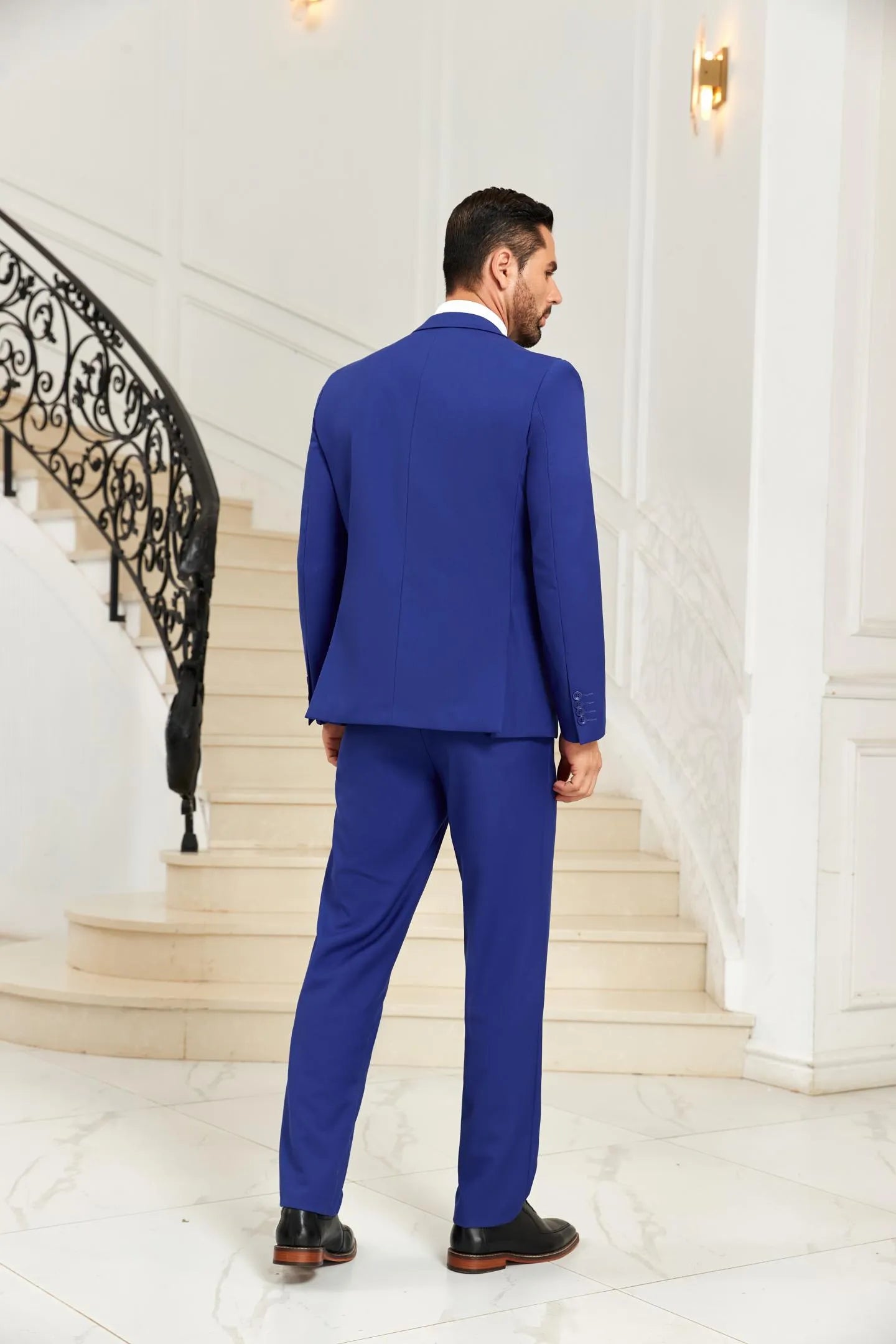 Back view of blue 3 piece men's suit showing blazer and pants design, tailored for weddings and formal occasions