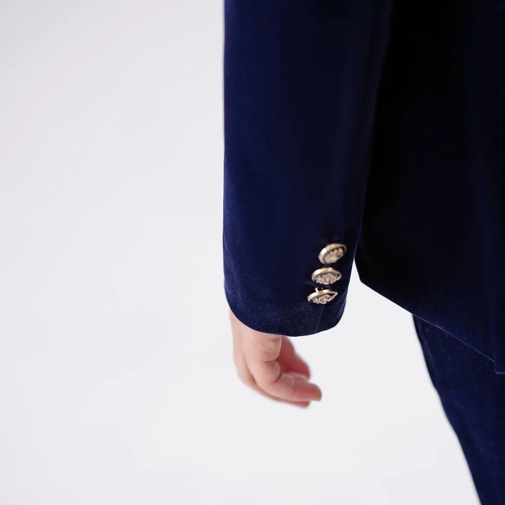Back collar close-up of navy velvet blazer – rich texture with structured stitching
