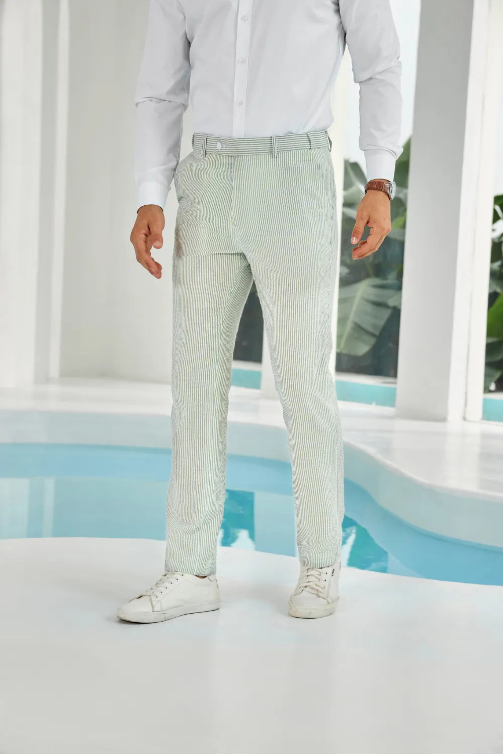 Front view of sage green striped seersucker pants paired with a white shirt, offering a stylish summer look.