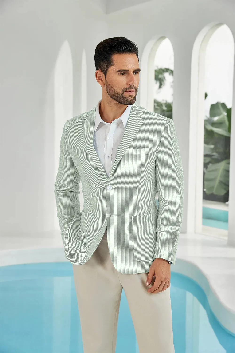 Men’s sage green and white striped seersucker blazer worn by a model, perfect for summer events.