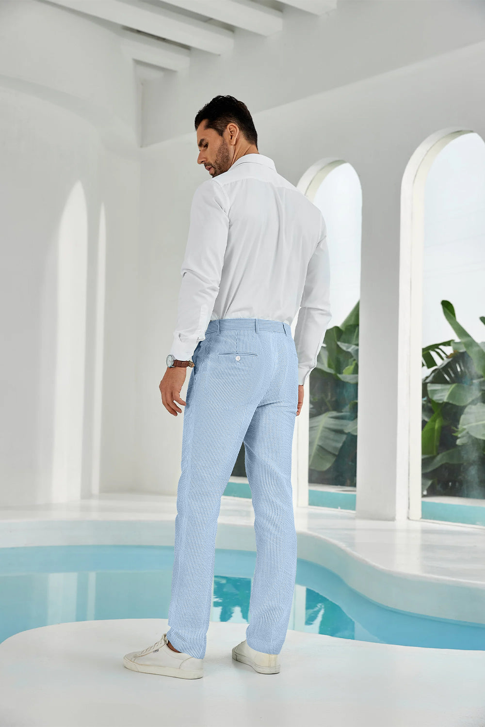 Three-quarter rear angle of sky blue pants showing slim fit and texture