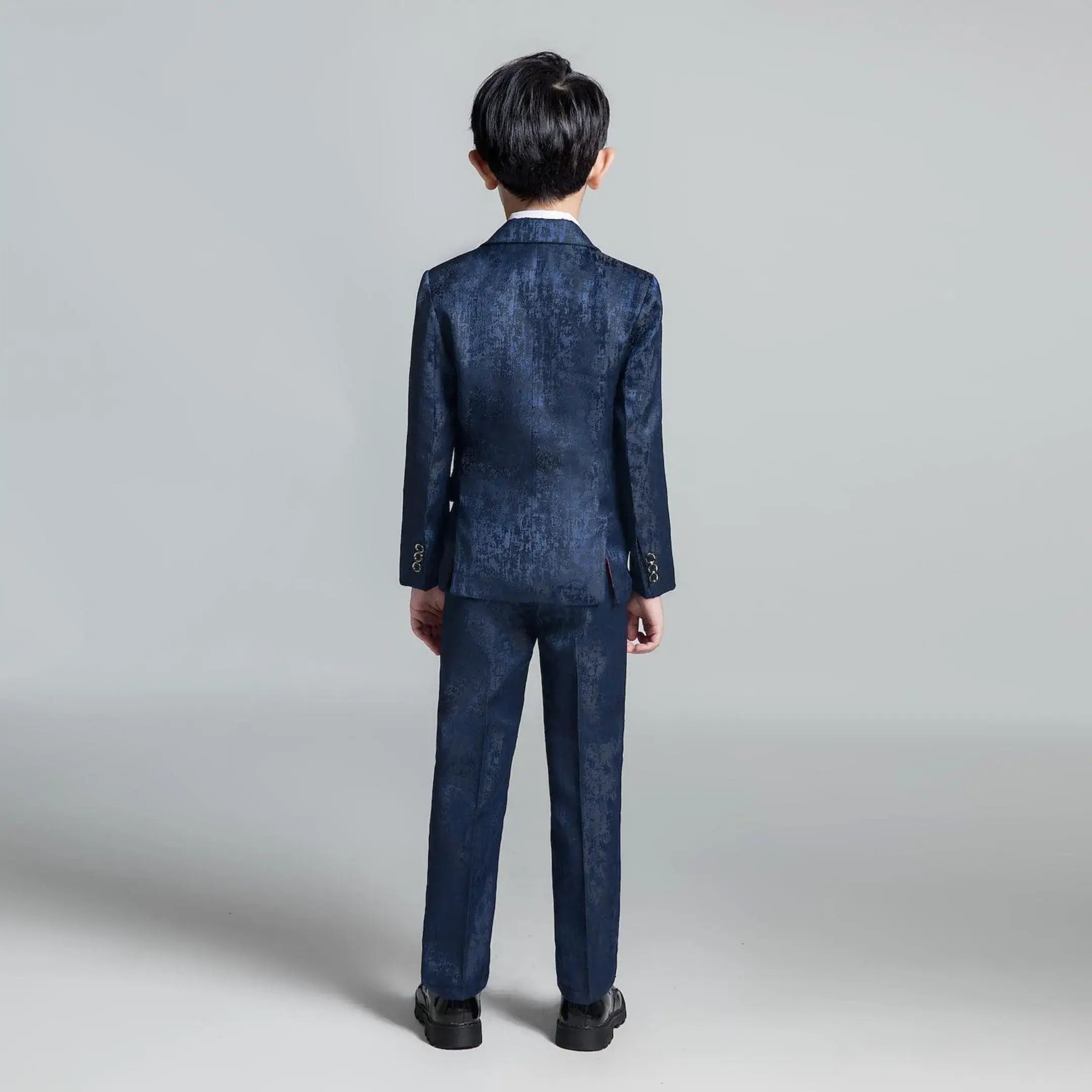 Back view of boys' dark blue floral suit with slim fit tailoring, modern formalwear for special occasions