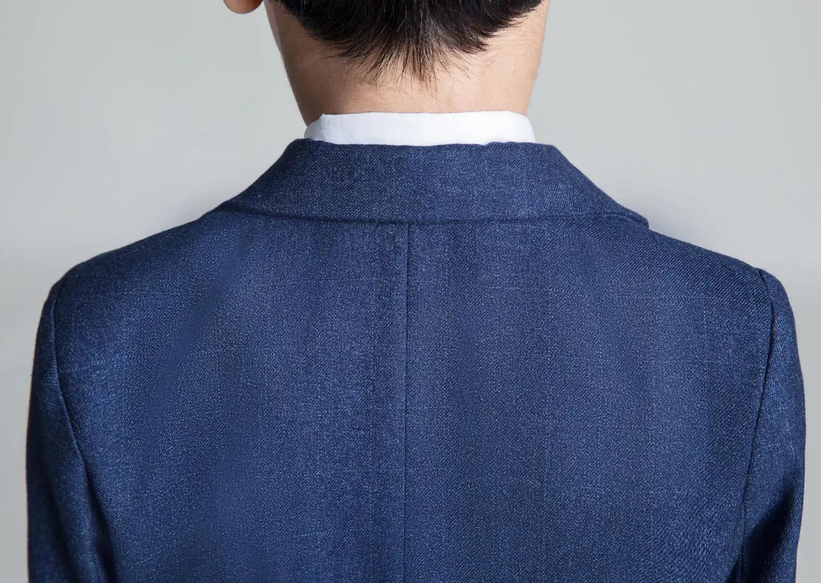 Close-up of back collar seam on navy check boys blazer – comfortable and elegant boys formalwear