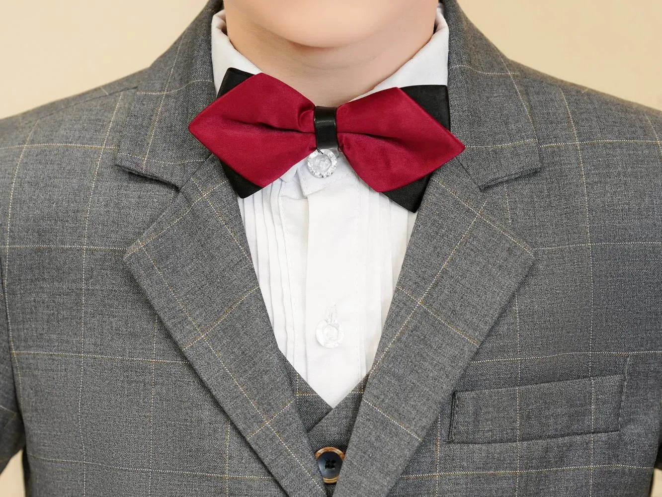 Grey plaid boys suit: Close-up of red bow tie & checked collar detail