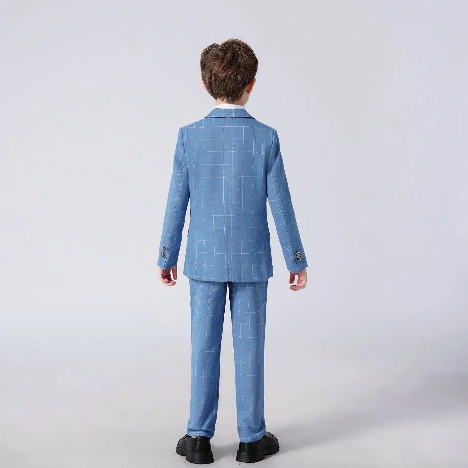 Back view of light blue checked boys formal suit showing jacket fit and pant length