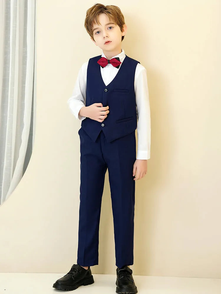 Navy boys’ vest and pants suit set with red bowtie and white shirt, perfect for ring bearer and birthday parties