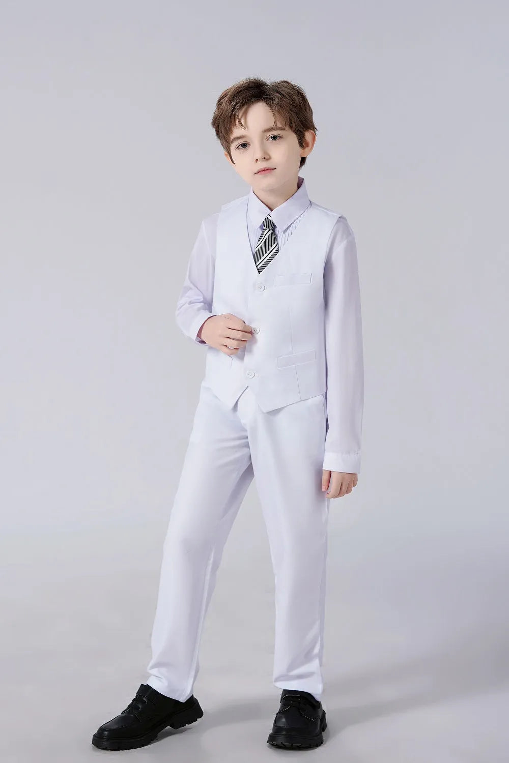 Boy in white vest suit with dress shirt and striped tie – stylish formalwear for boys' weddings or parties