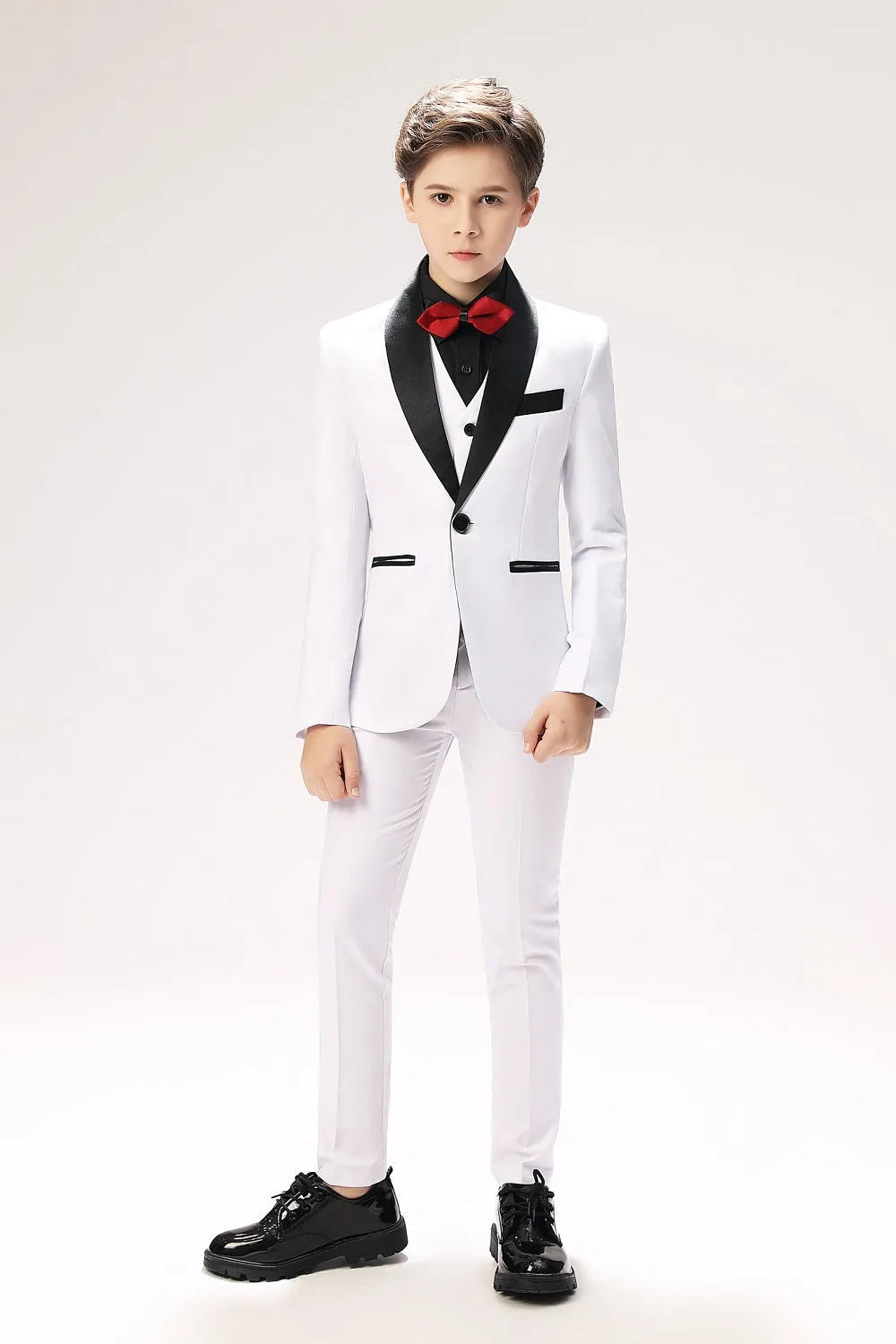 White toddler prom suit with black lapel and red bow tie