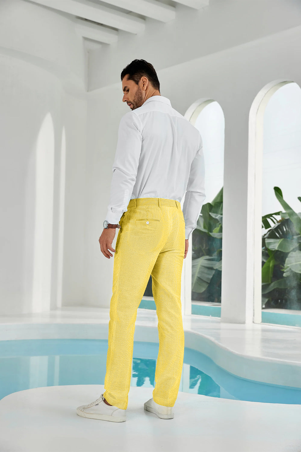 Three-quarter rear angle of yellow pants showing slim fit and texture