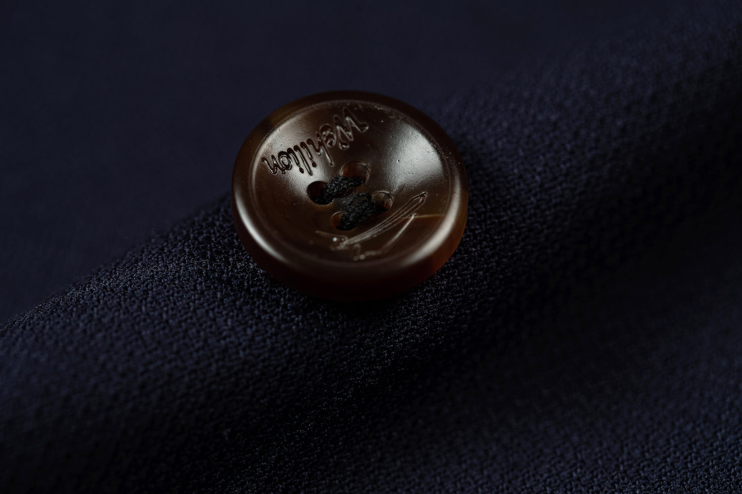 Men's navy double breasted blazer button - engraved horn button with textured fabric background