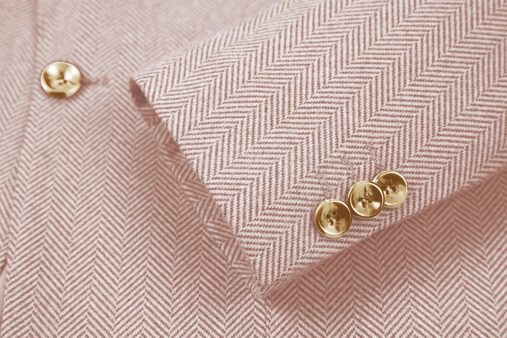 Detailed shot of men's retro herringbone leather pink business suit sleeve – emphasizing classic tailored fit