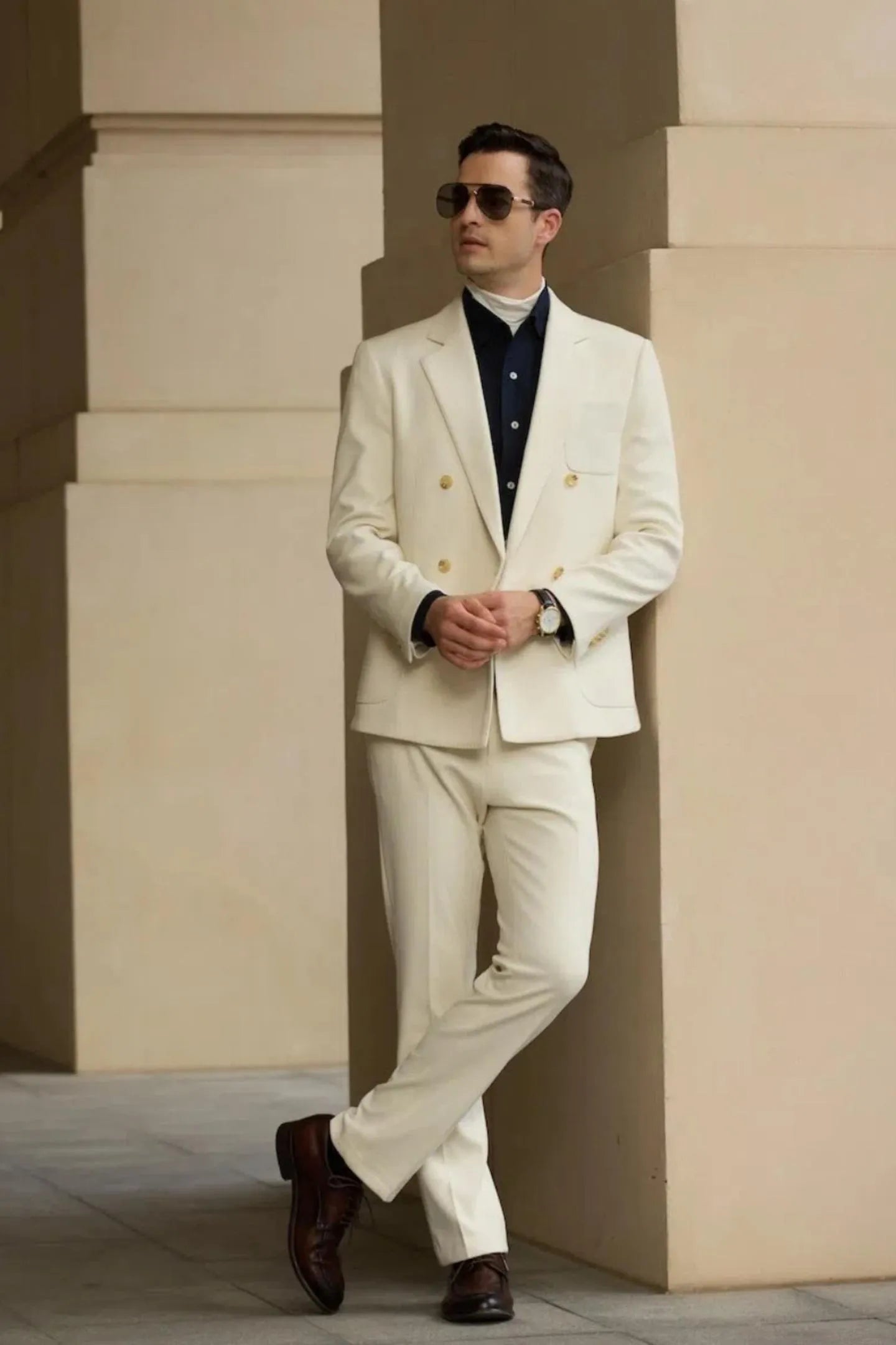 Model wearing white double breasted herringbone tweed 2 piece men's suit with blazer and trousers, styled for wedding look