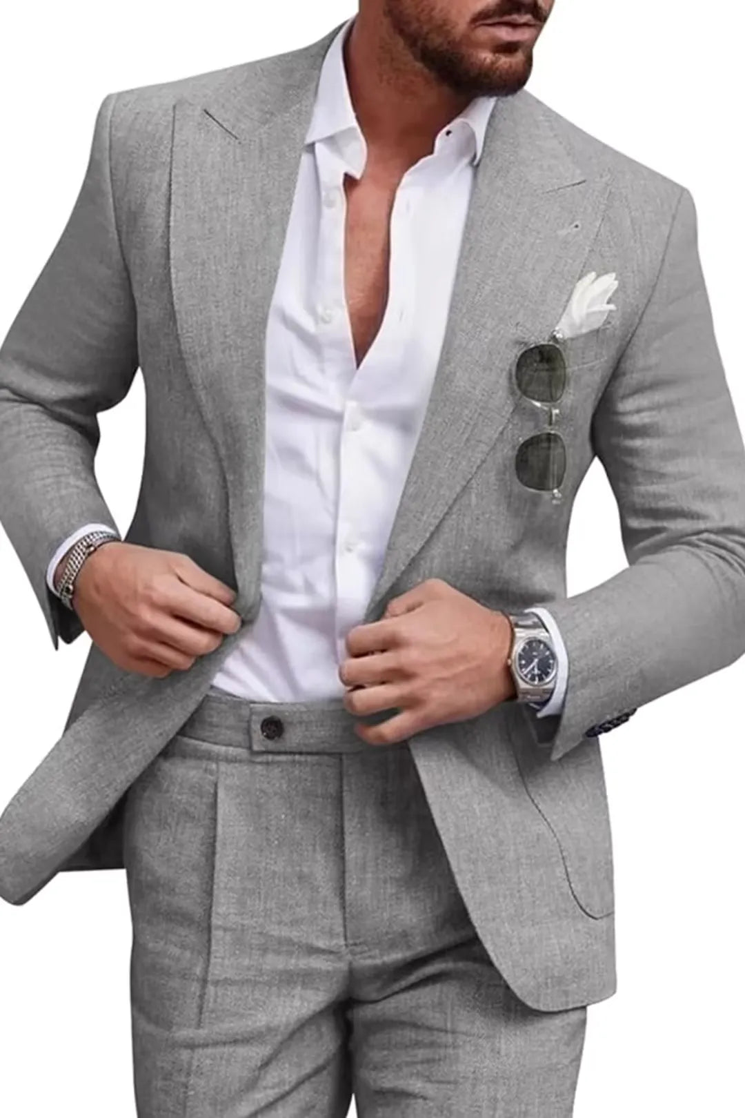 Man in grey slim fit linen 2 piece summer suit with peaked lapel blazer and trousers, styled for formal or wedding occasions.