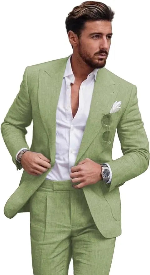 Man in sage green slim fit linen 2 piece summer suit with peaked lapel blazer and trousers, styled with shirt for casual or wedding wear.