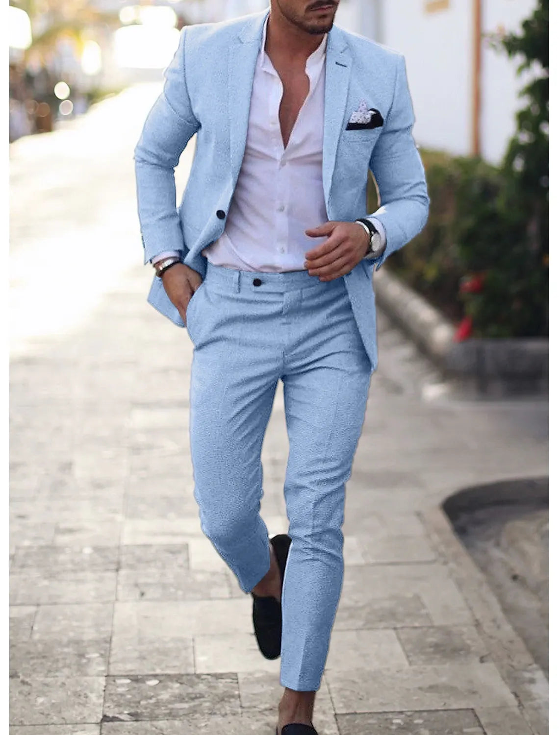 Close-up of light blue men's summer blazer paired with matching trousers and pocket square.