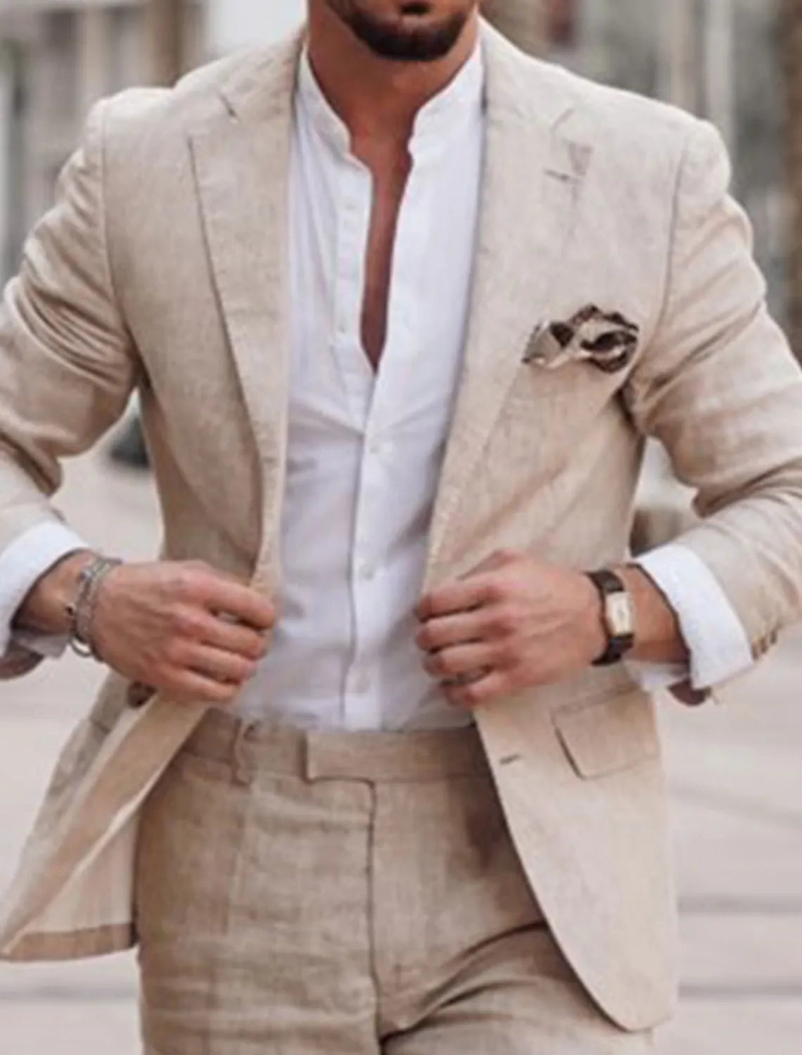Men's beige linen suit with white shirt and pocket square in outdoor setting