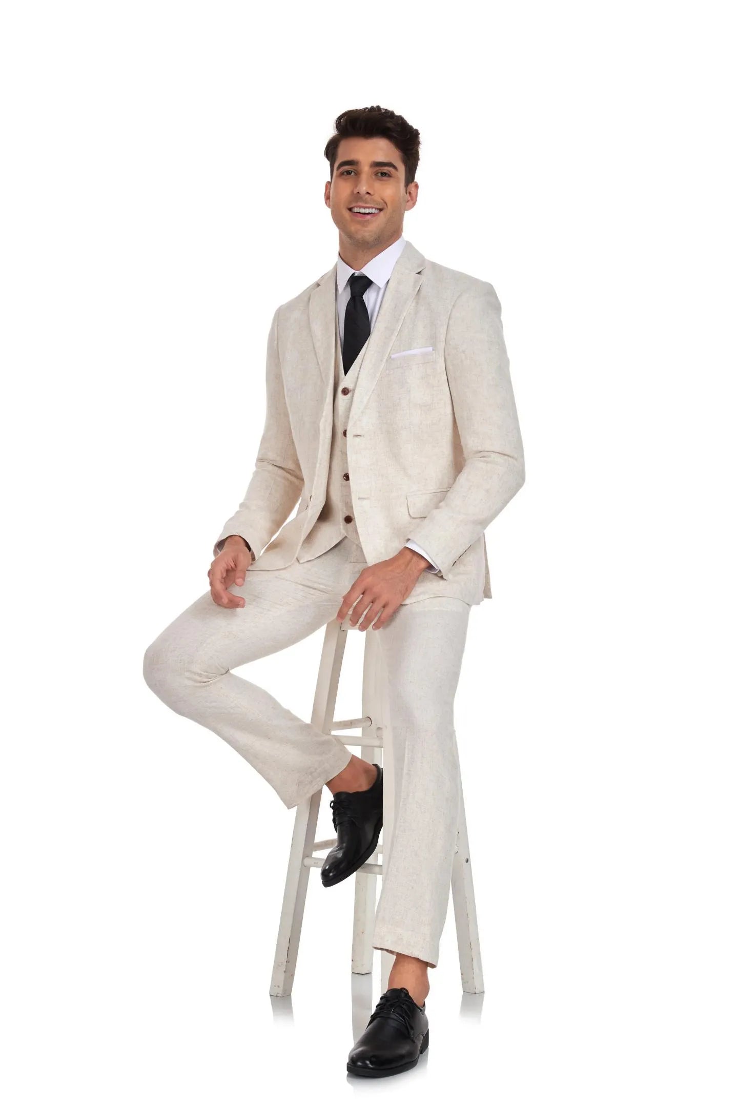 seated model wearing beige grey 3 piece linen suit for men – retro casual wedding look with blazer and vest