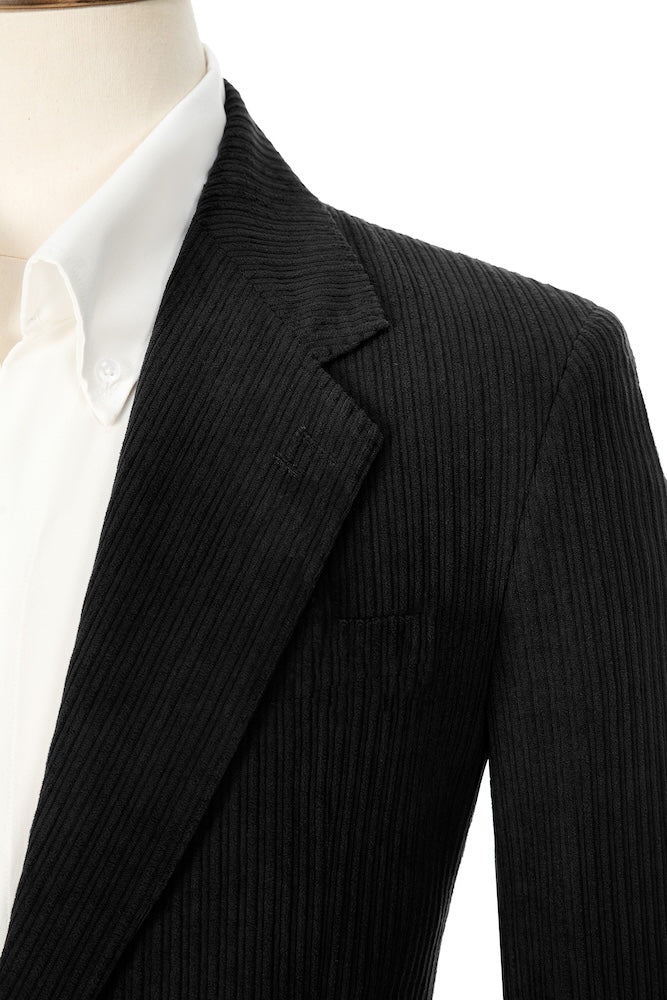 Close-up of black corduroy prom blazer lapel – textured fabric, elegant cut
