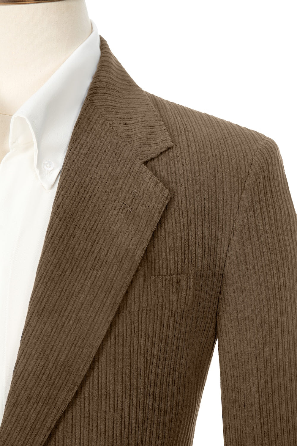 Close-up of brown corduroy prom blazer lapel – textured fabric, elegant cut