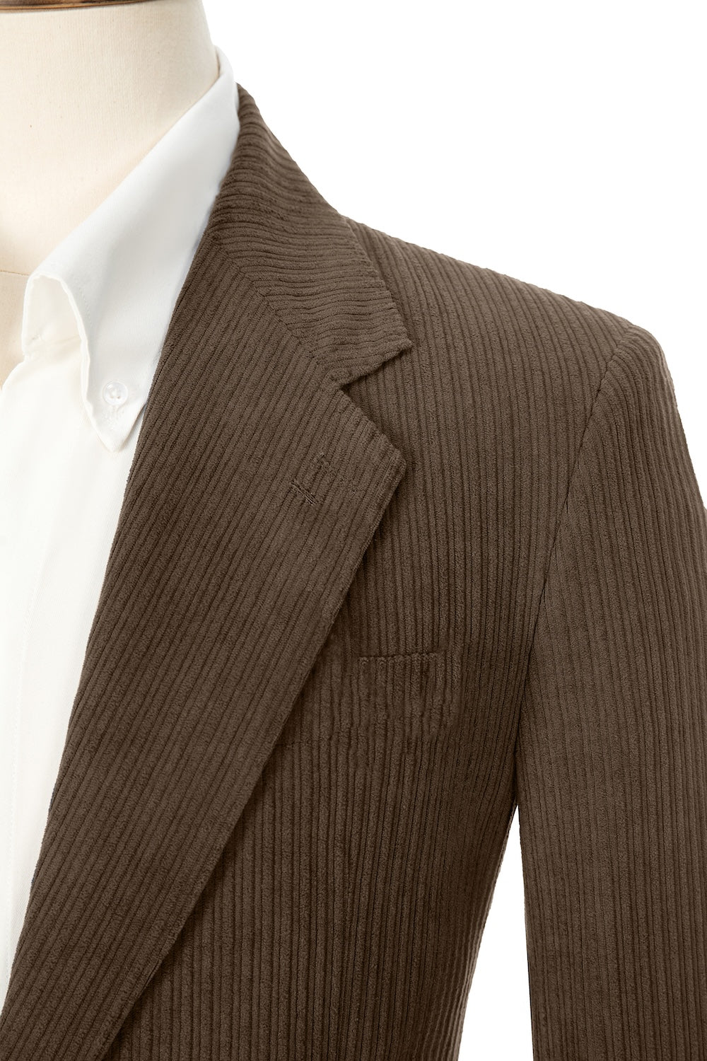 Close-up of dark brown corduroy prom blazer lapel – textured fabric, elegant cut