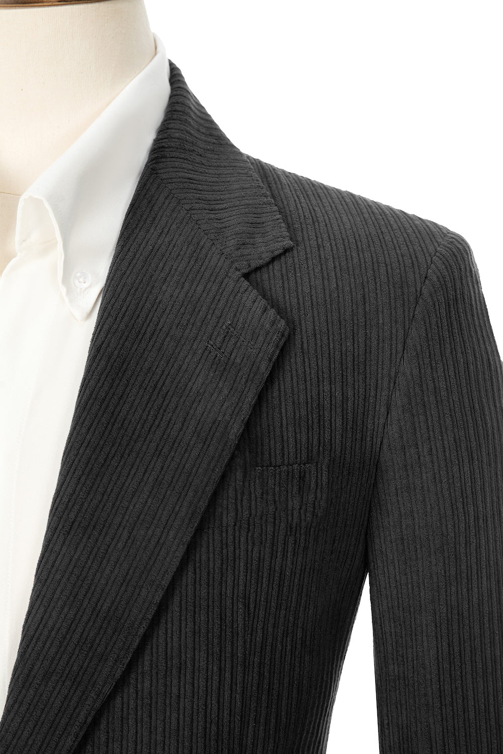 Close-up of dark grey corduroy prom blazer lapel – textured fabric, elegant cut