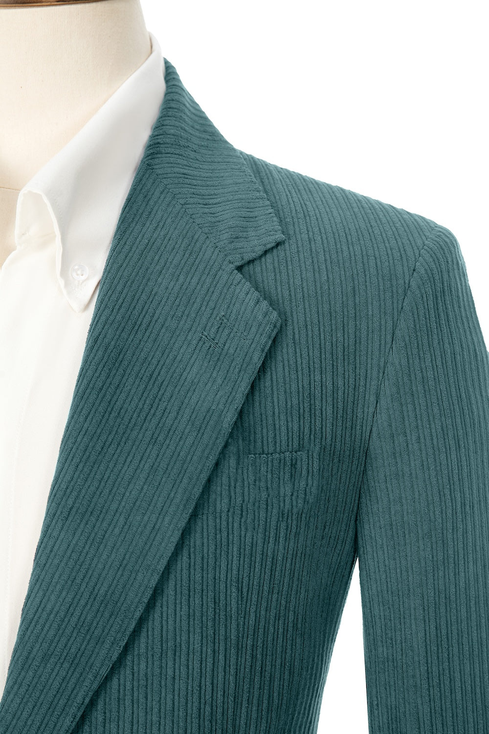 Close-up of fruit green corduroy prom blazer lapel – textured fabric, elegant cut