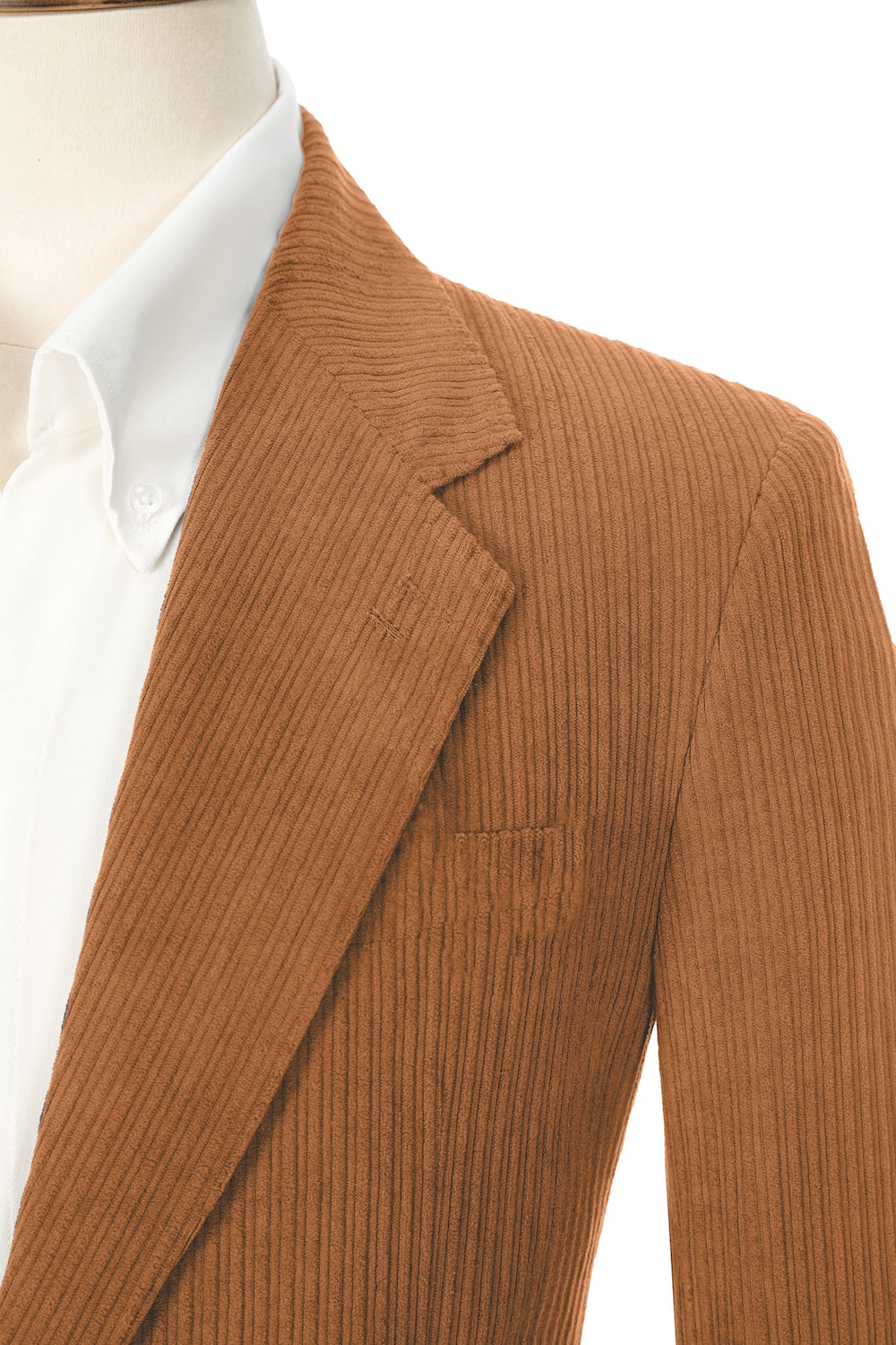 Close-up of orange corduroy prom blazer lapel – textured fabric, elegant cut