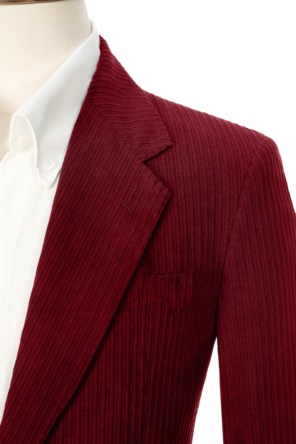 Close-up of retro red corduroy blazer lapel – textured fabric with clean lines