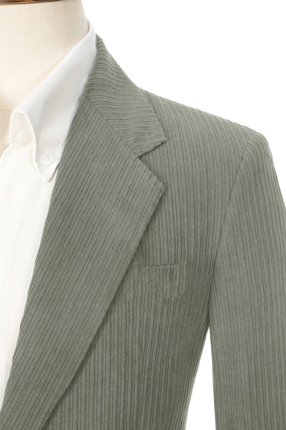 Close-up of sage green corduroy prom blazer lapel – textured fabric, elegant cut