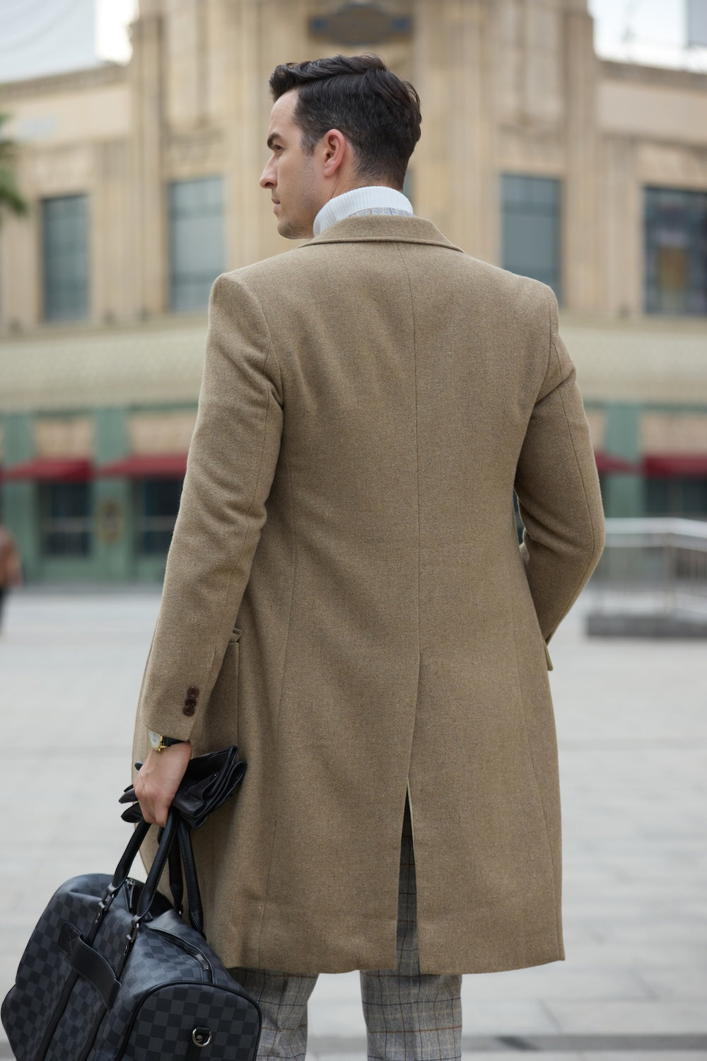 Khaki wool overcoat for men – back view with bag in hand
