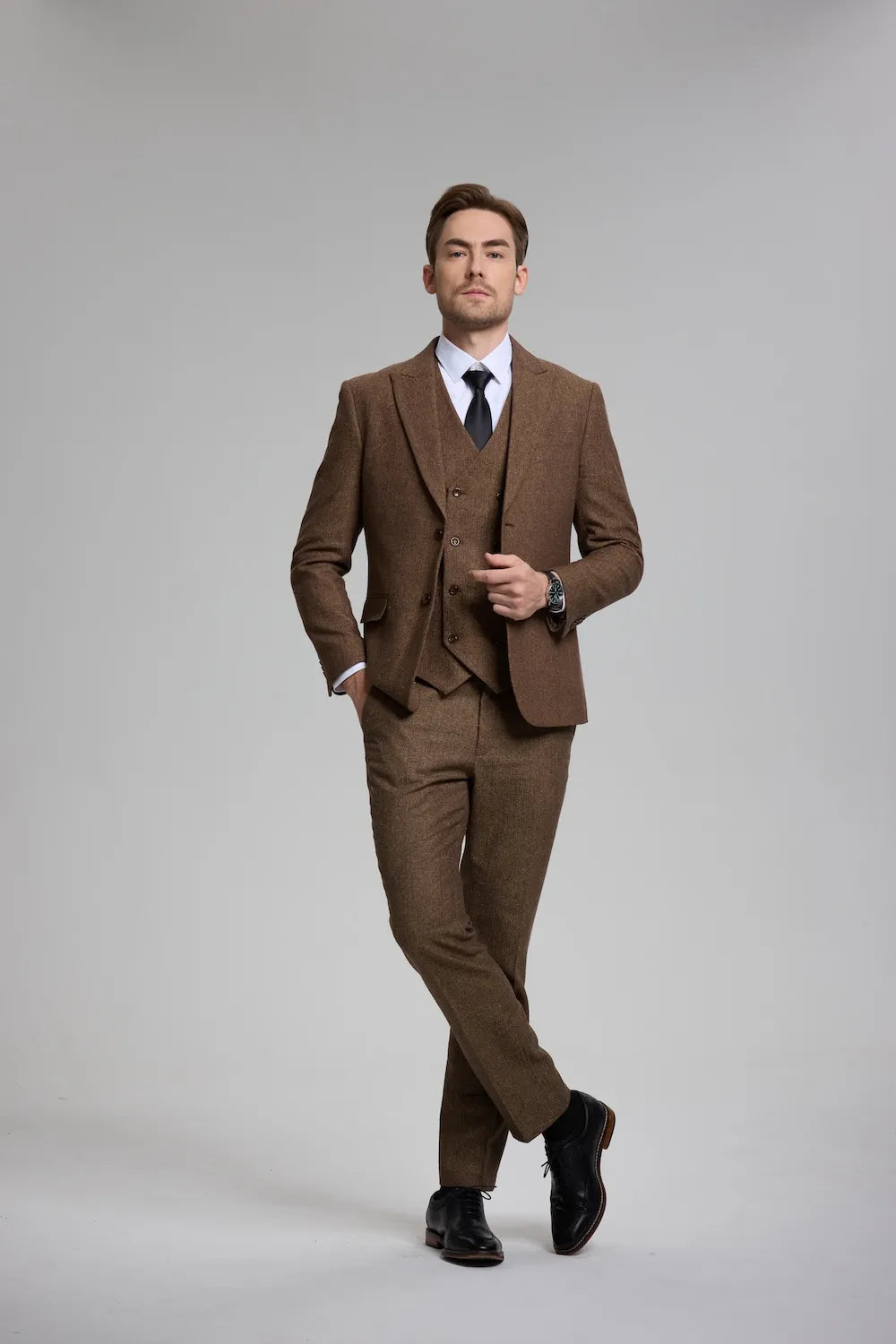 Man wearing a brown Versatile Herringbone 3-Piece Suit, featuring a tailored blazer, waistcoat, and trousers.