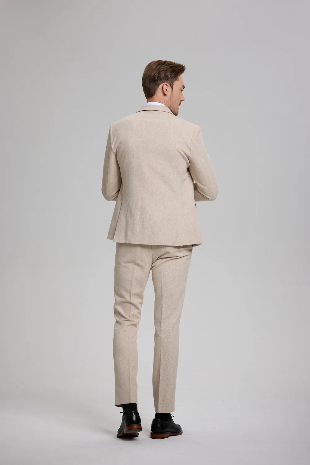 Back view of a champagne Versatile Herringbone 3-Piece Suit, highlighting the clean lines and sophisticated fit