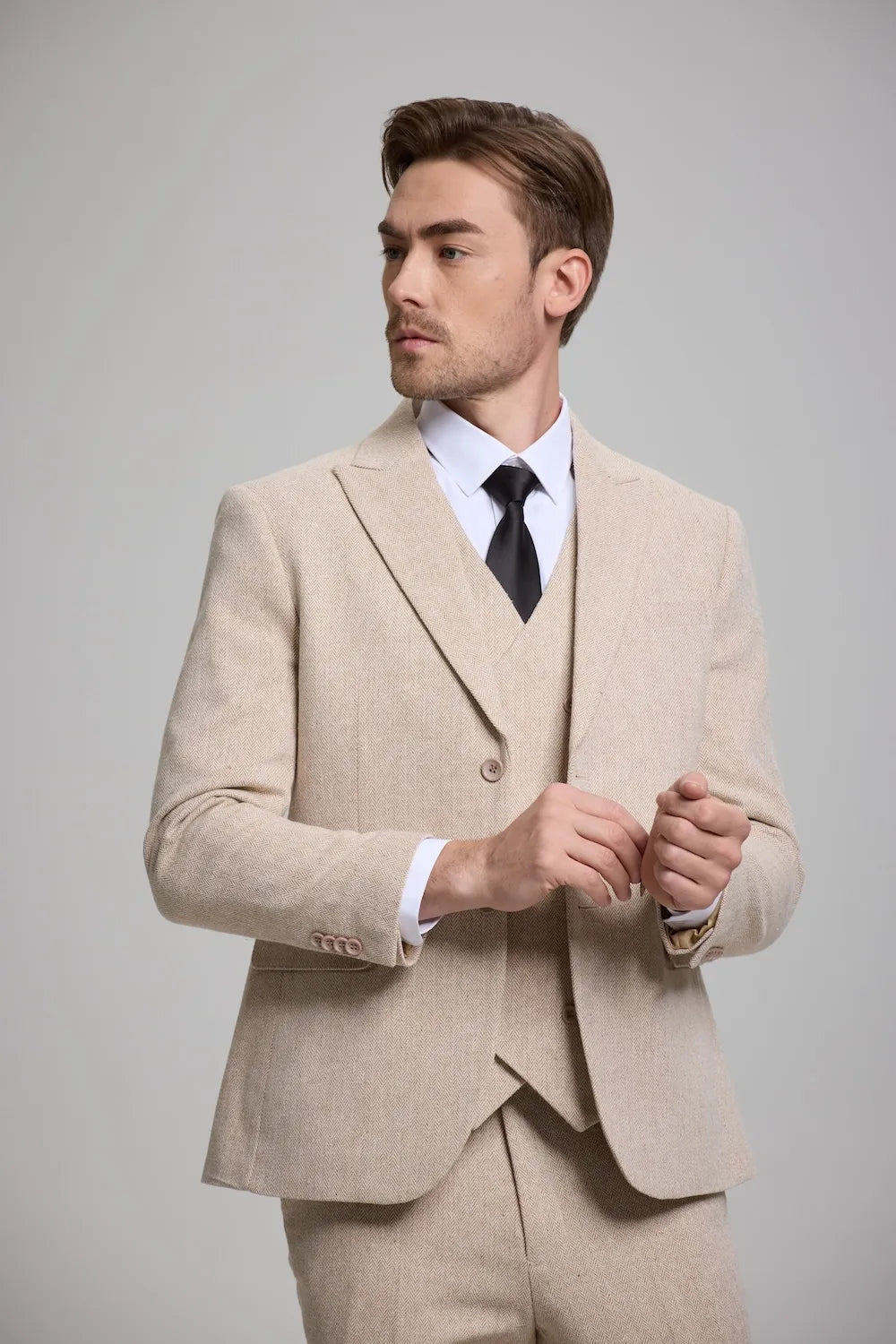 Close up of a champagne Versatile Herringbone 3-Piece Suit for Men, showcasing sharp tailoring and a modern fit.