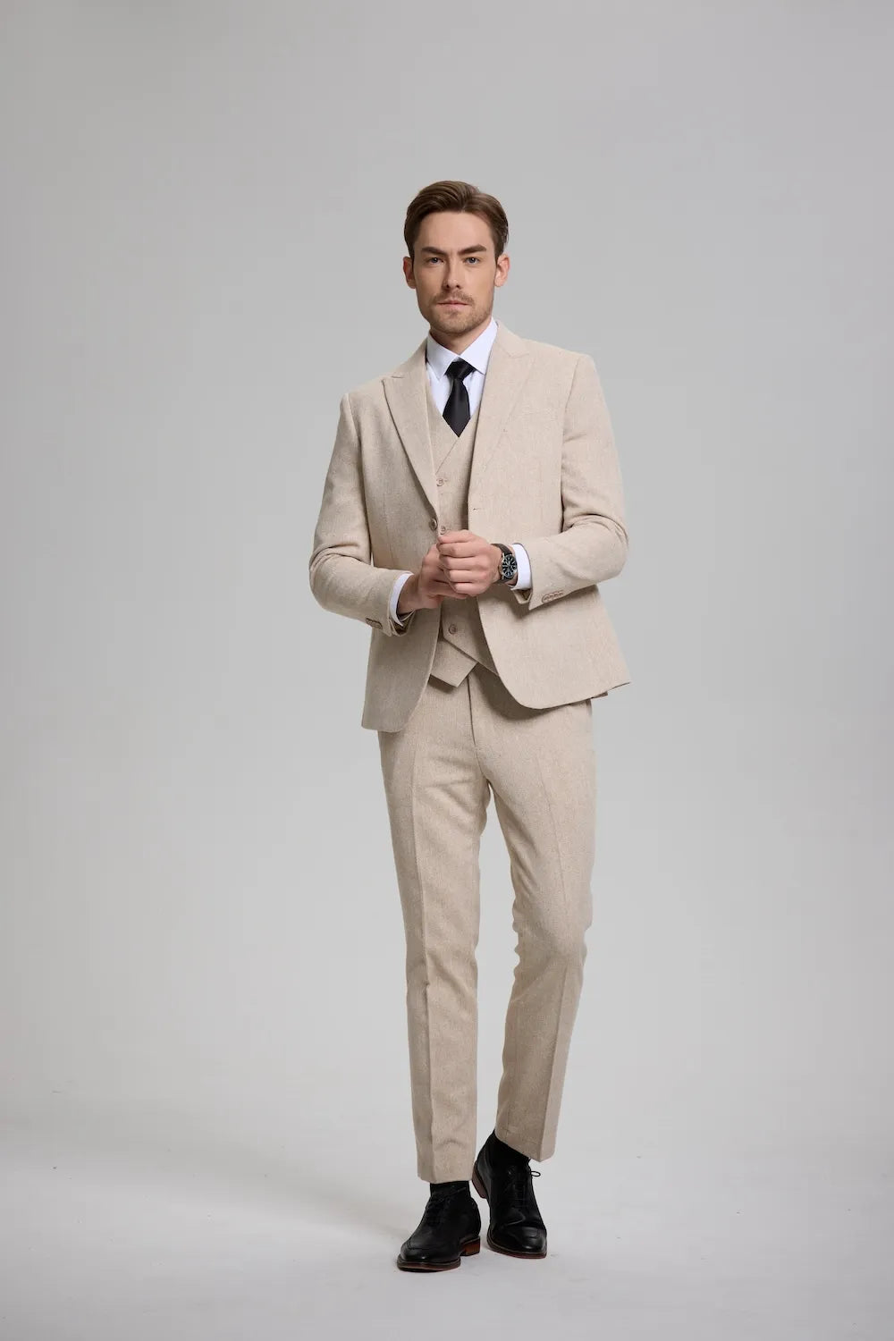 Man wearing a champagne Versatile Herringbone 3-Piece Suit, featuring a tailored blazer, waistcoat, and trousers.