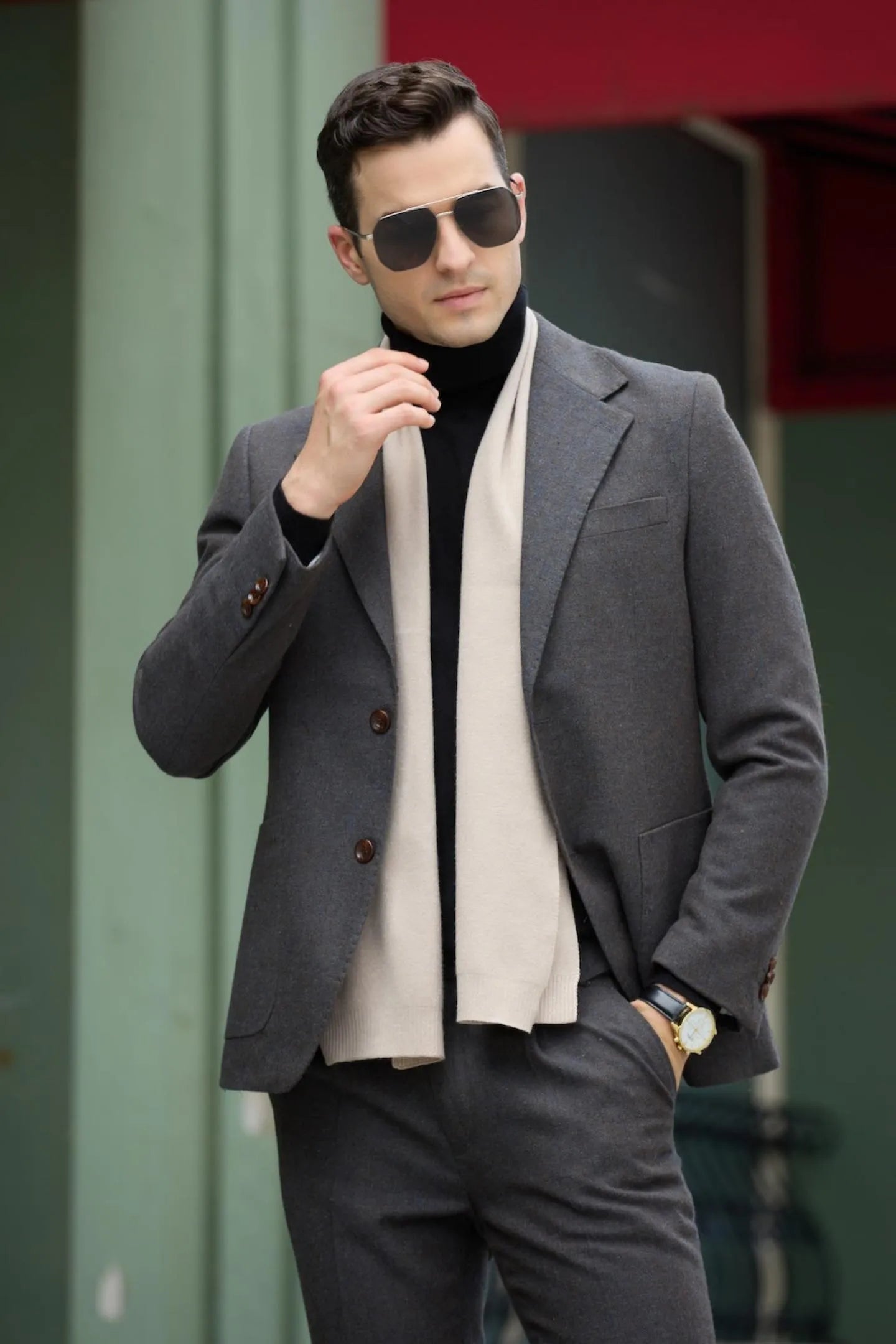 close-up shot of men's dark grey retro herringbone wool blend 2 piece suit – slim fit business wear, highlighting the blazer details and beige scarf.