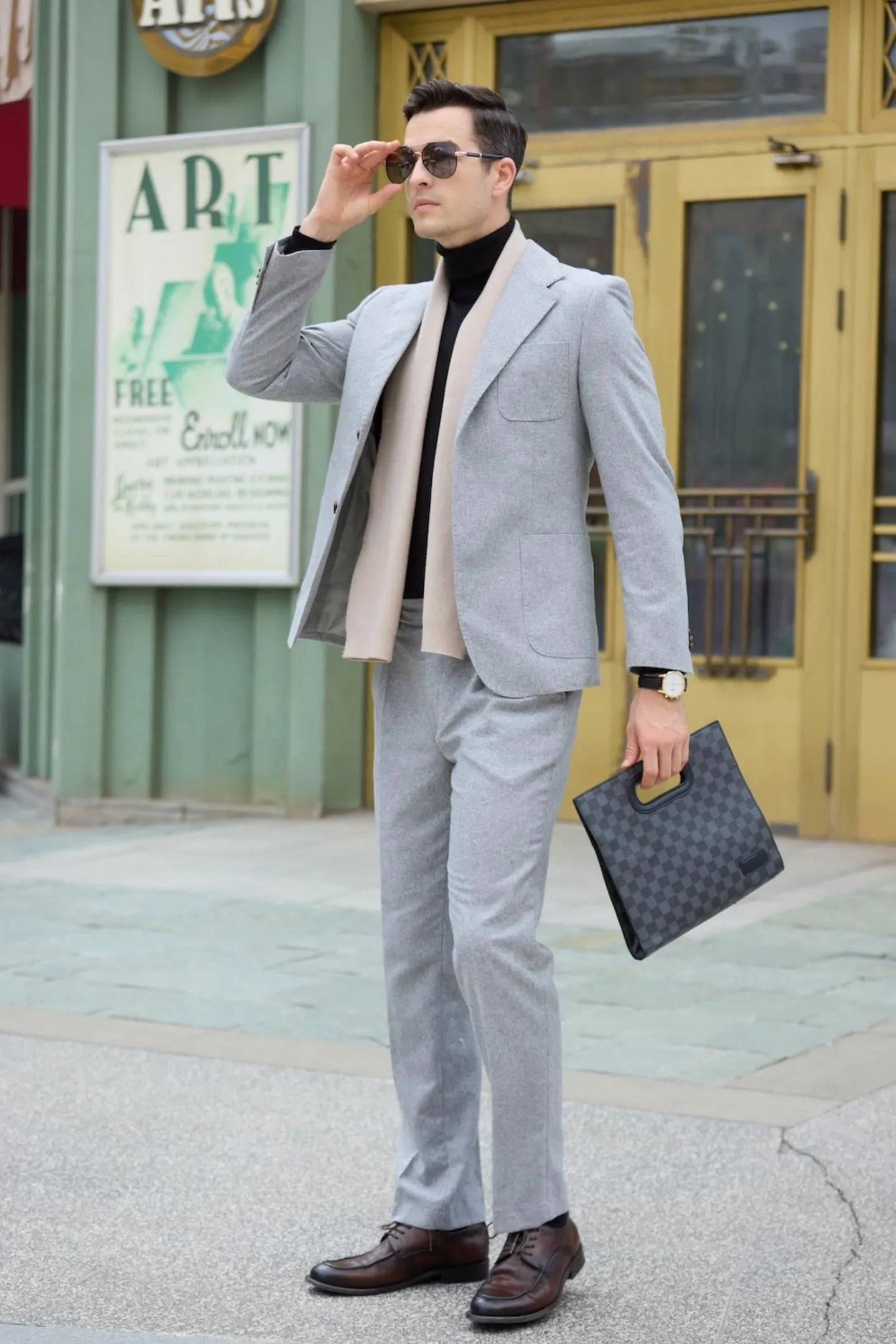 waist-up shot of men's gray herringbone two-piece suit, perfect for casual business or semi-formal occasions.