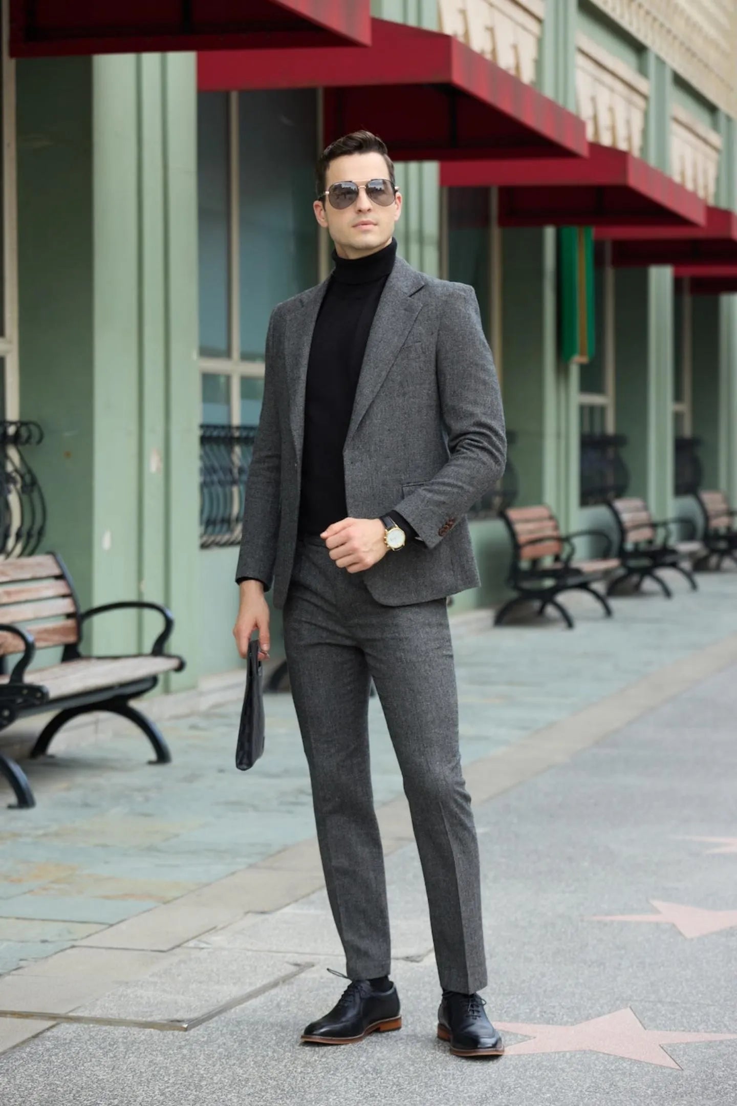 front view of men's dark grey tweed herringbone 2 piece suit with slim fit, paired with black turtleneck and black shoes.