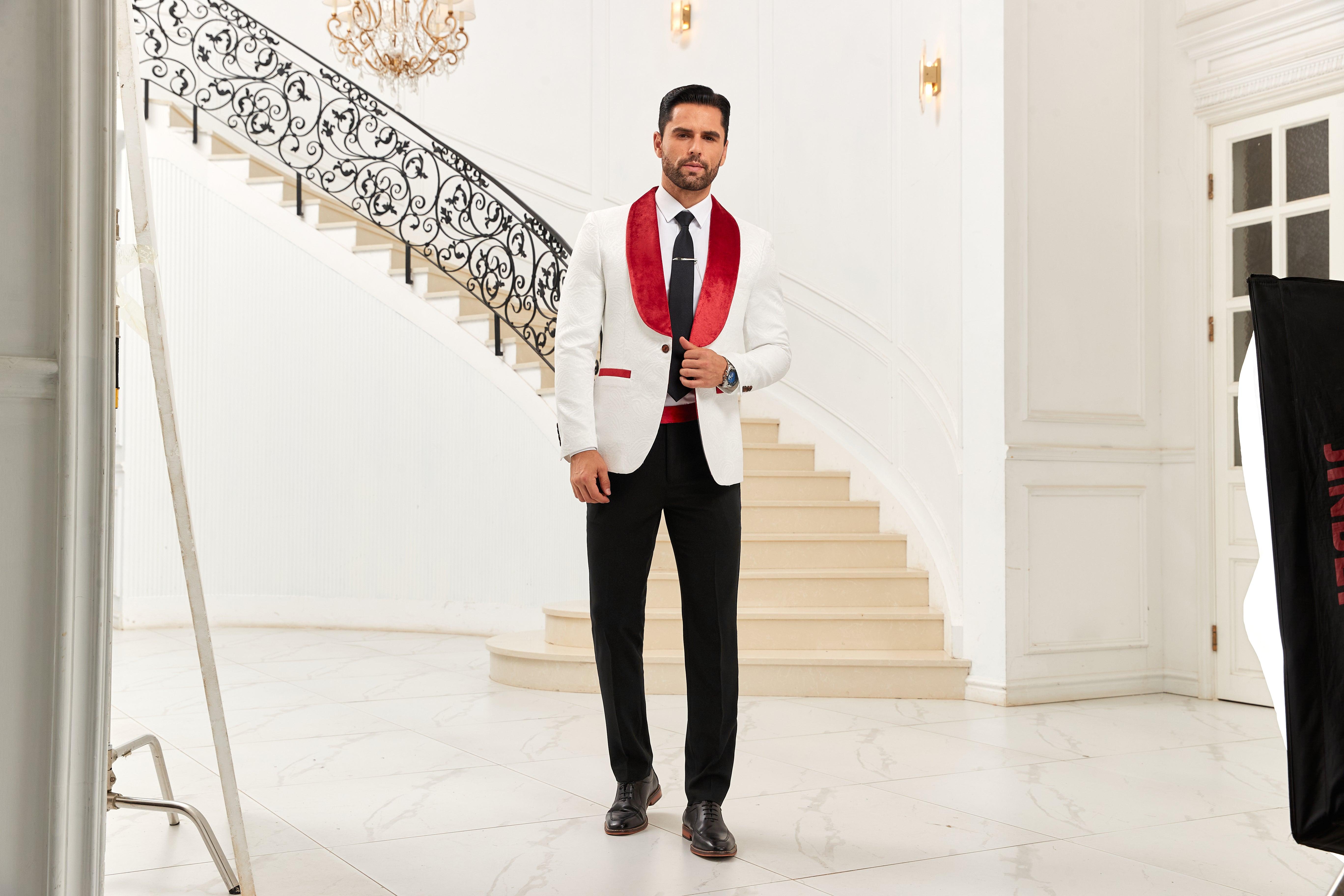 Stylish men's blazer with a red shawl collar paired with sleek black trousers in an elegant setting